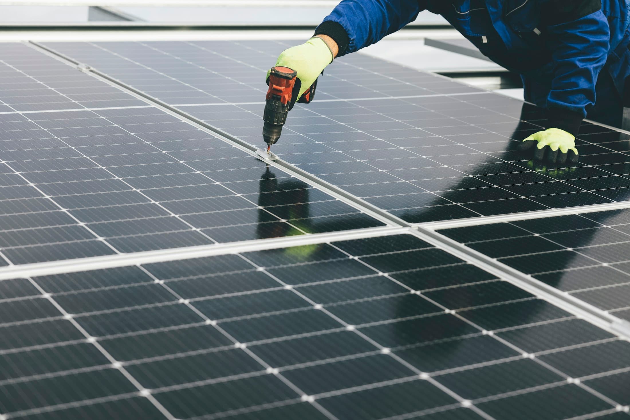 Technician installing photovoltaic panels on site
