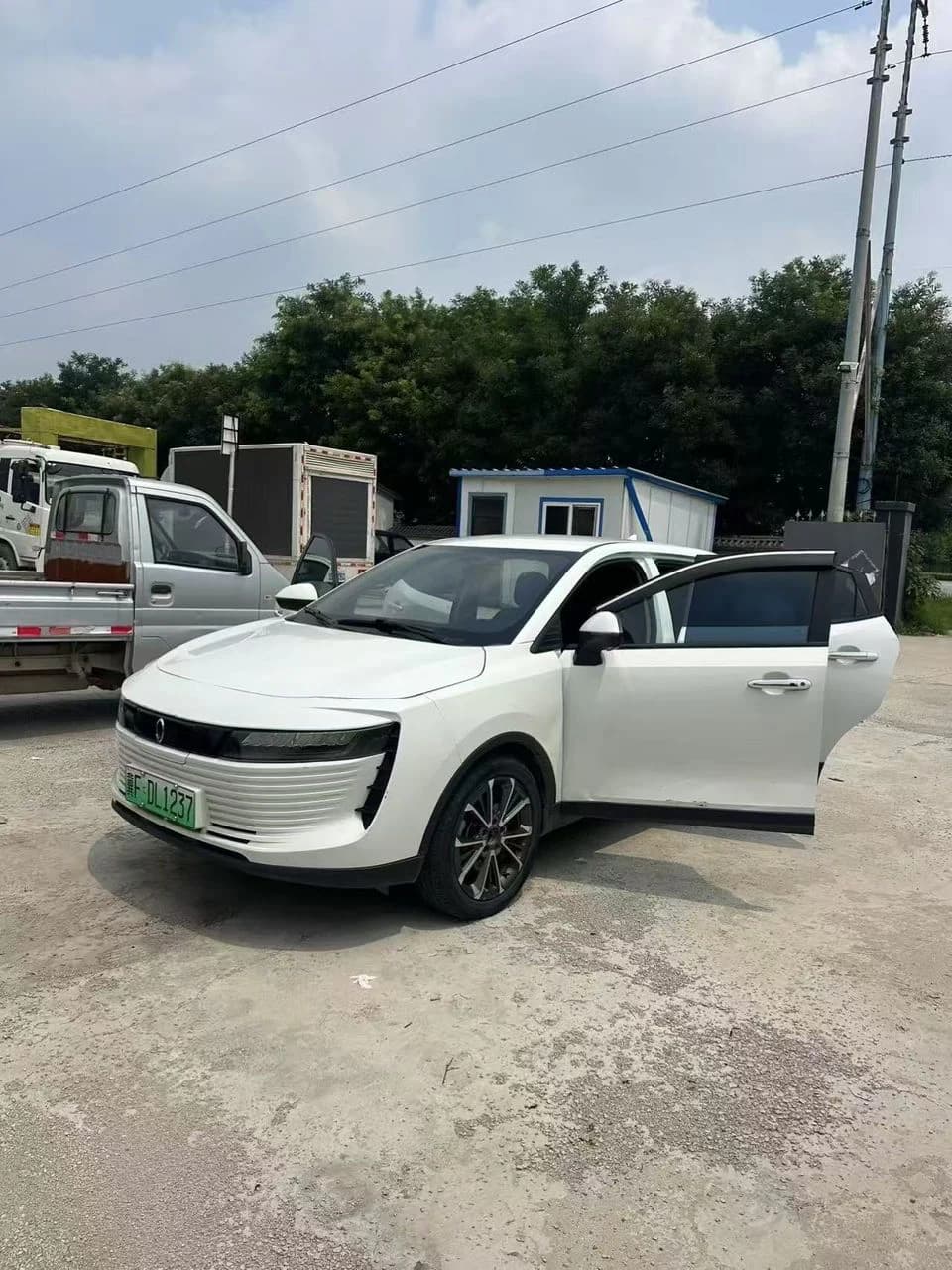 White electric vehicle with its passenger doors open