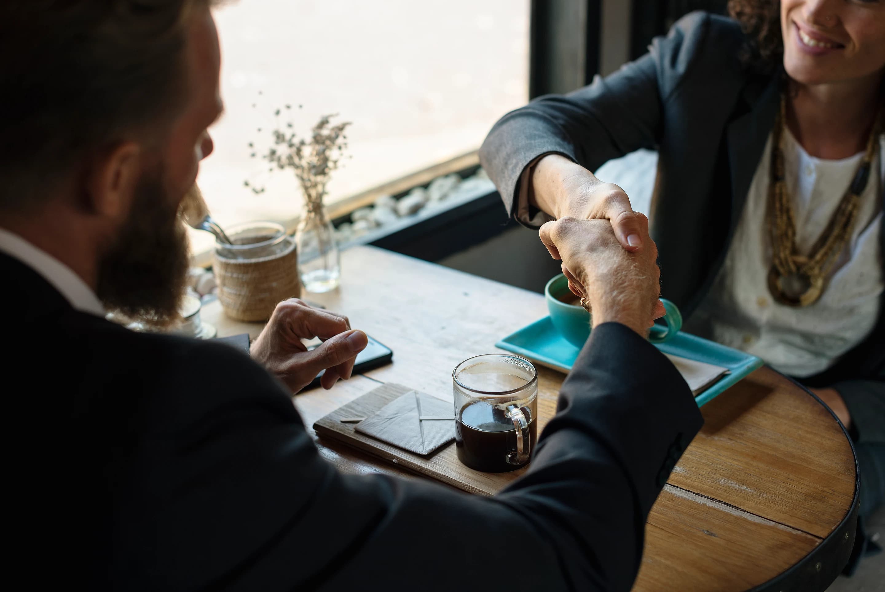 Business partners shaking hands during a planning meeting